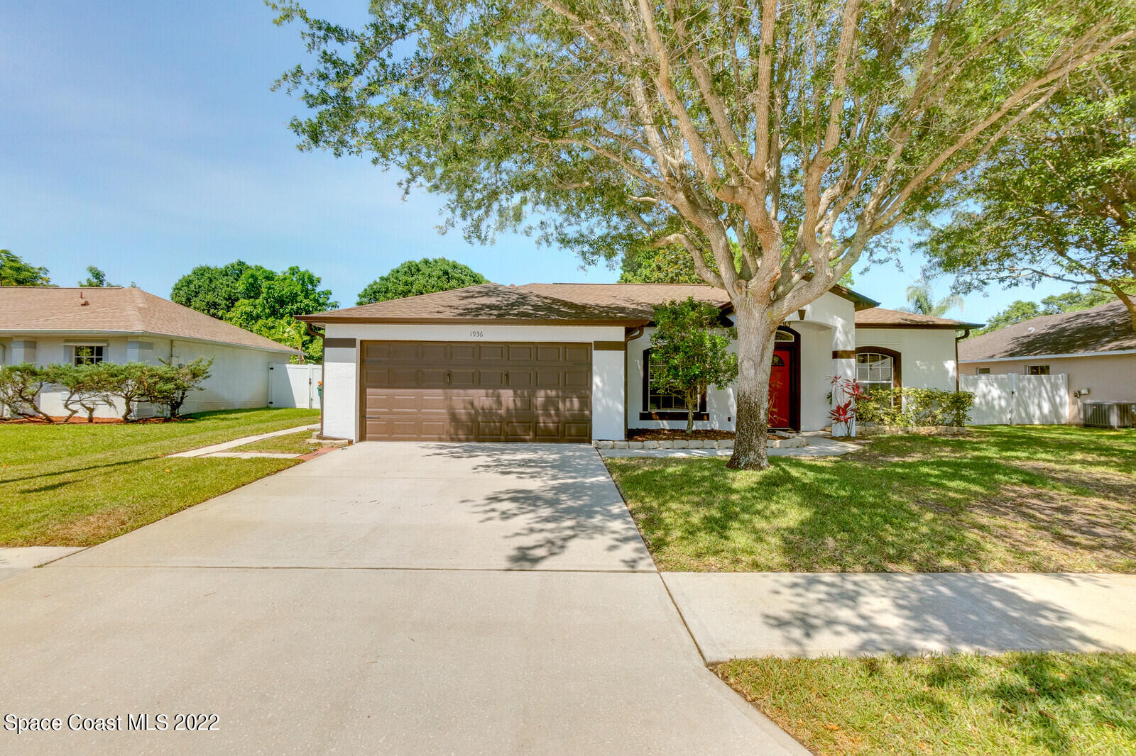 1936 Blue Ridge Avenue Melbourne, FL 32935 - Photo 3 of 35 a front view of a house with a garden and trees