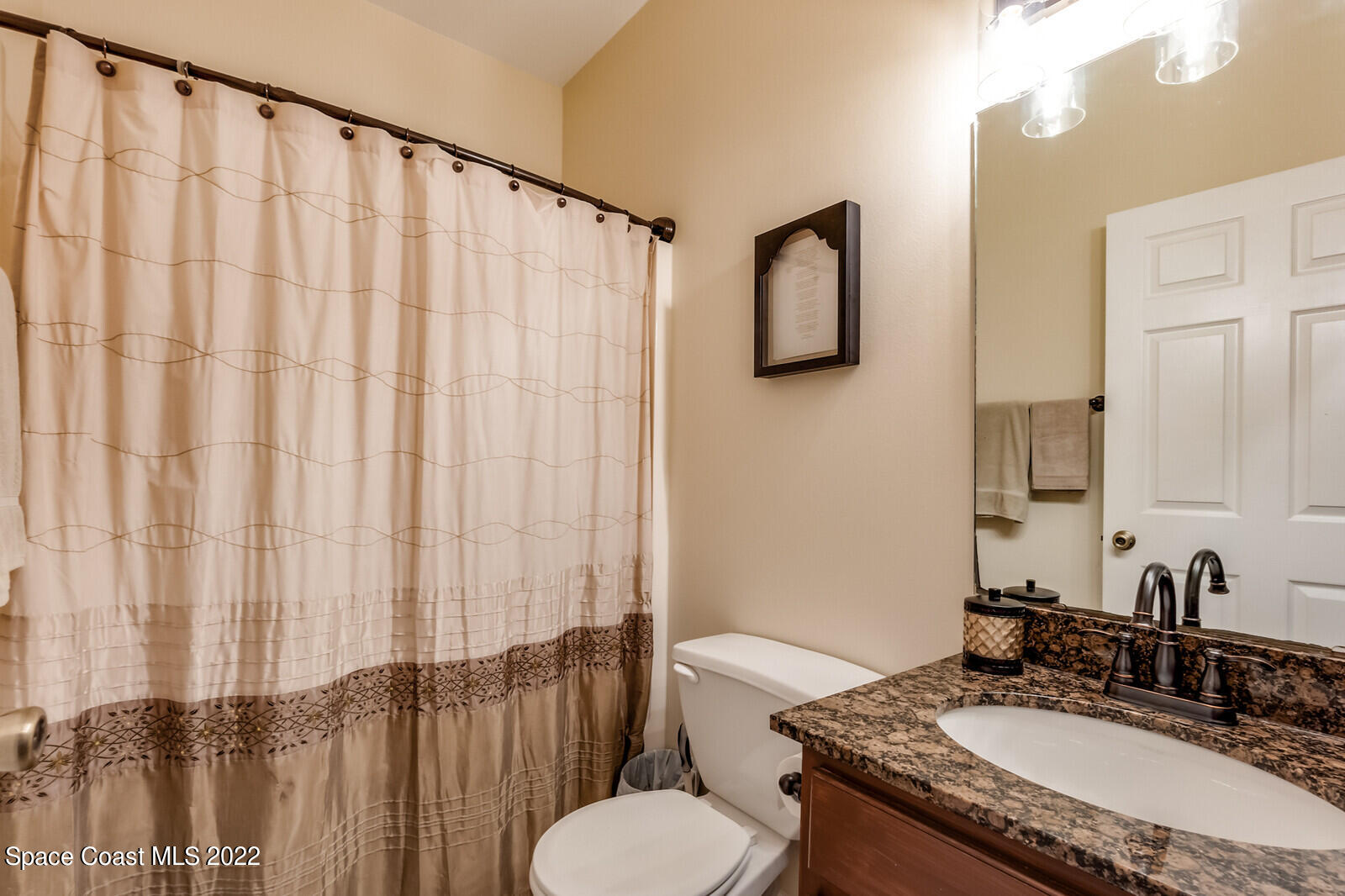 1936 Blue Ridge Avenue Melbourne, FL 32935 - Photo 34 of 35 a bathroom with a granite countertop sink and a mirror