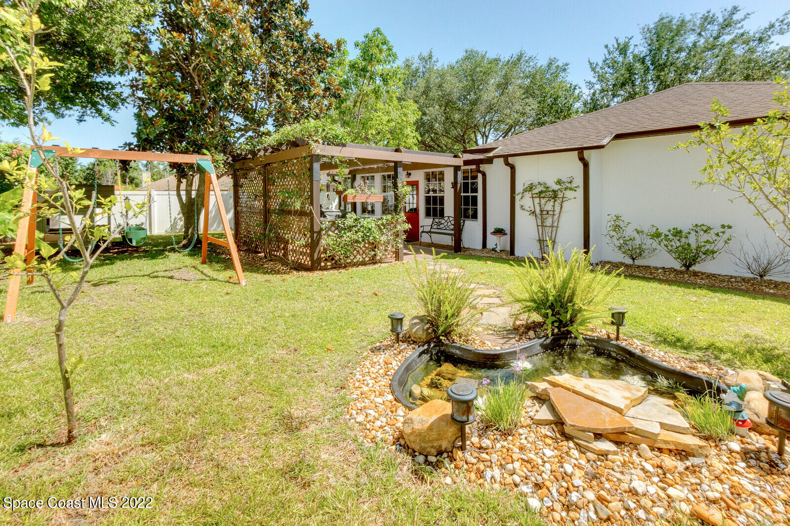 1936 Blue Ridge Avenue Melbourne, FL 32935 - Photo 5 of 35 a front view of a house with swimming pool outdoor seating and yard