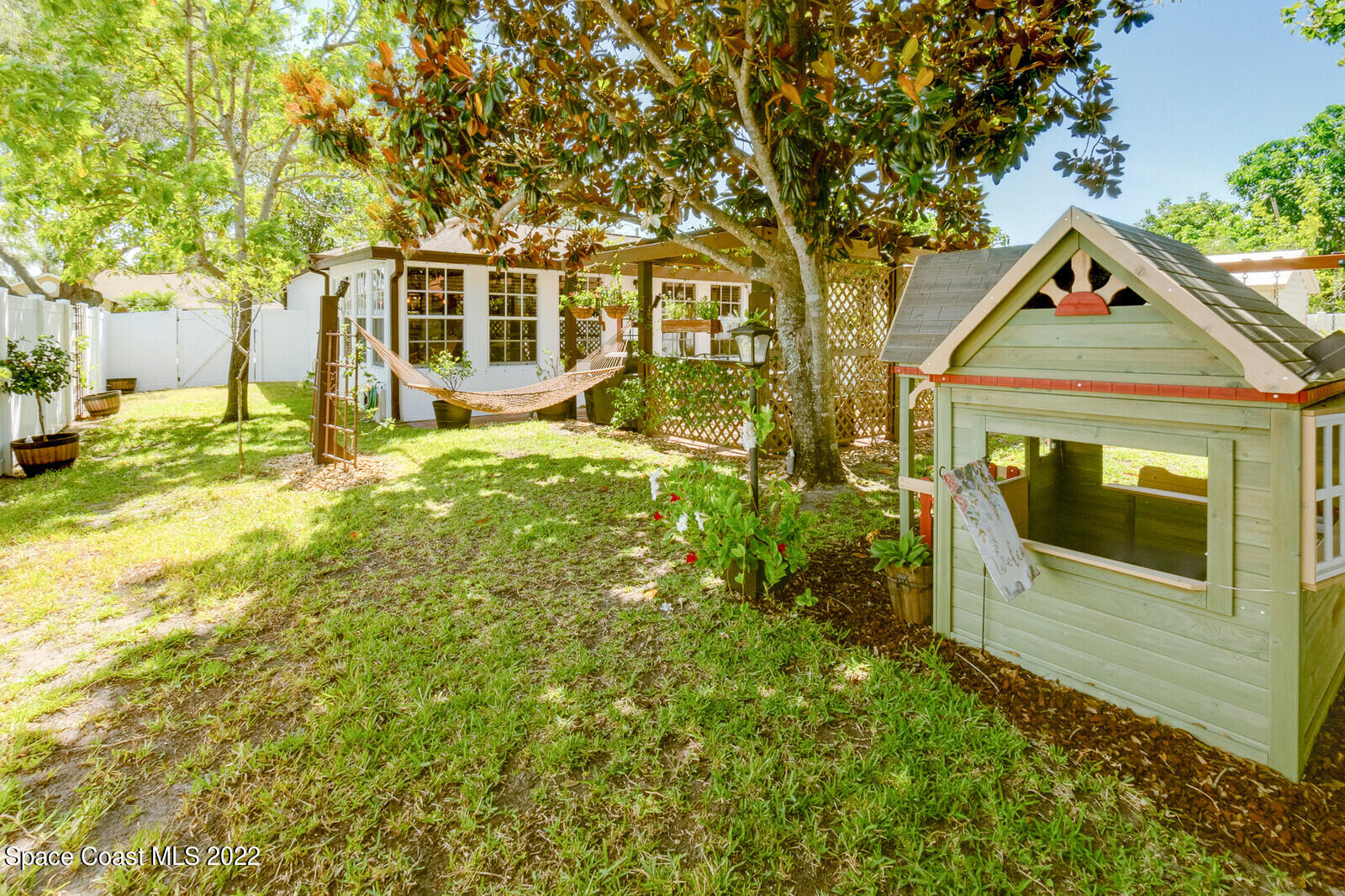 1936 Blue Ridge Avenue Melbourne, FL 32935 - Photo 6 of 35 a yellow house with trees in front of it