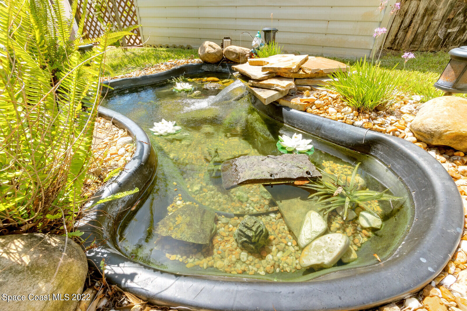 1936 Blue Ridge Avenue Melbourne, FL 32935 - Photo 8 of 35 a view of a swimming pool with a yard and plants