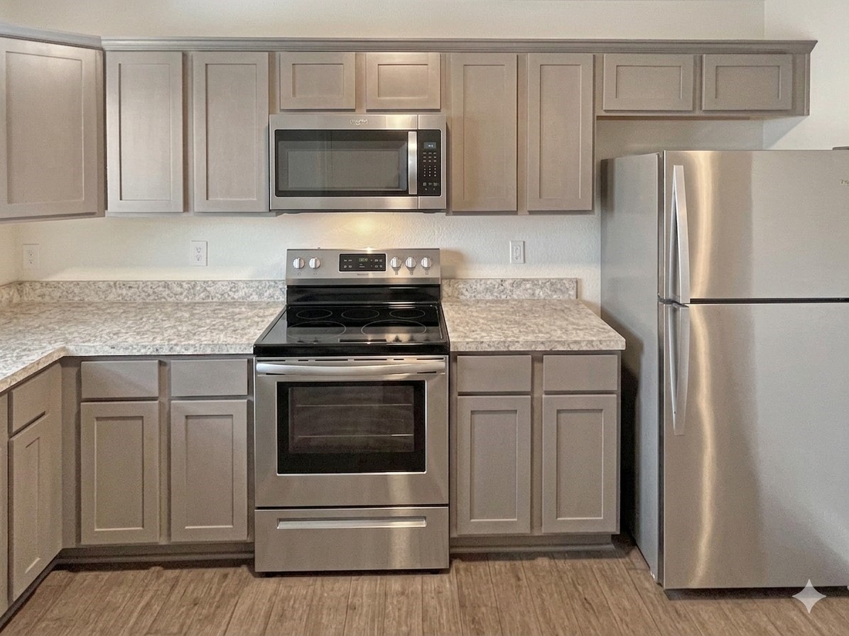 12603 Telge Road, Unit 8EH Cypress, TX 77429 - Photo 11 of 32 a kitchen with white cabinets and stainless steel appliances