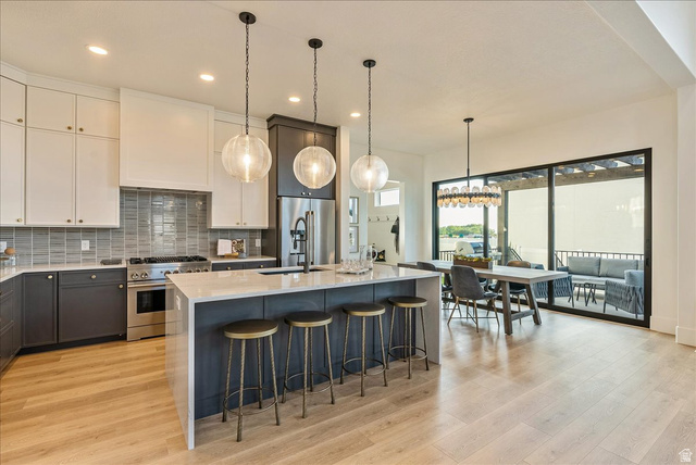 2458 West Aurora Avenue, Unit 287 Mapleton, UT 84664 - Photo 8 of 24 Kitchen with backsplash, light stone counters, pendant lighting, high end appliances, and recessed lighting