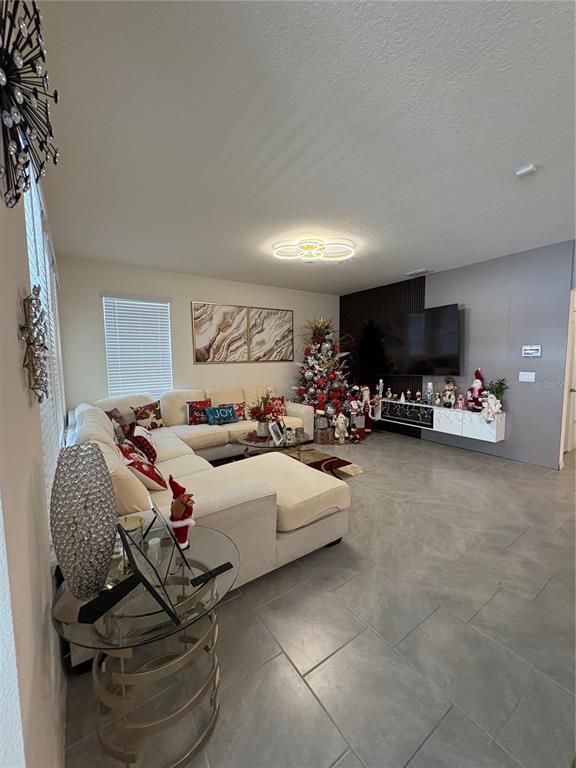 1948 Rankin Street Kissimmee, FL 34744 - Photo 11 of 37 a bedroom with furniture and a flat screen tv