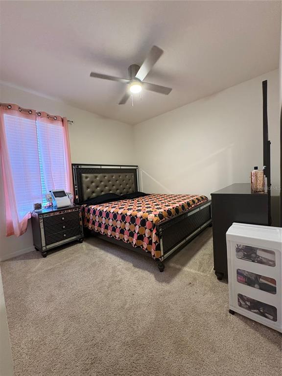 1948 Rankin Street Kissimmee, FL 34744 - Photo 31 of 37 a bedroom with a bed and a ceiling fan