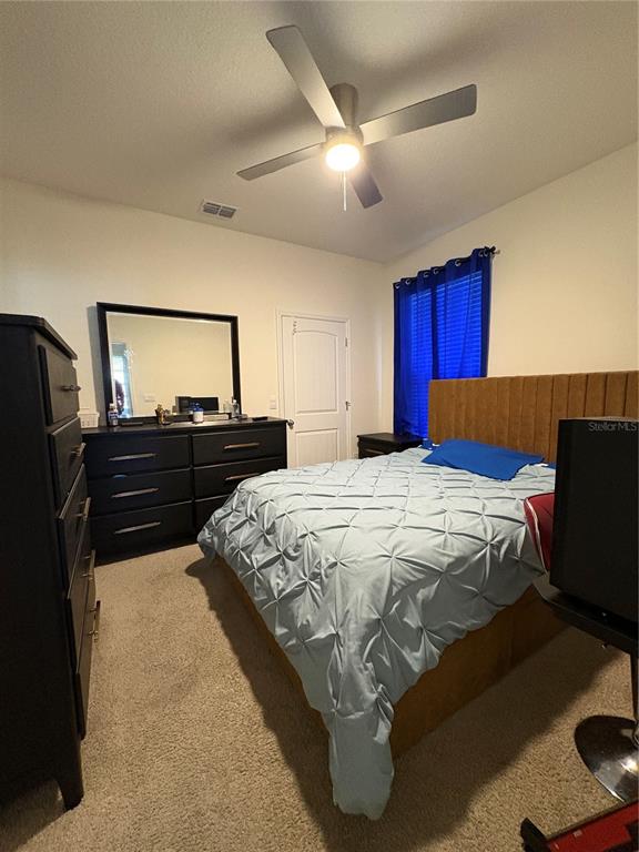 1948 Rankin Street Kissimmee, FL 34744 - Photo 7 of 37 a bedroom with a bed and dresser