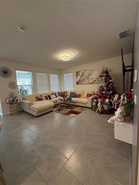 1948 Rankin Street Kissimmee, FL 34744 - Photo 10 of 37 a living room with furniture and a flat screen tv