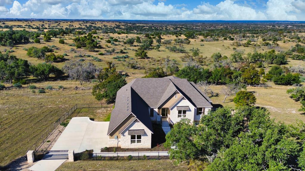 an aerial view of a house with a yard