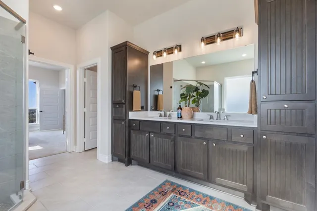 a spacious bathroom with a sink a mirror and a shower