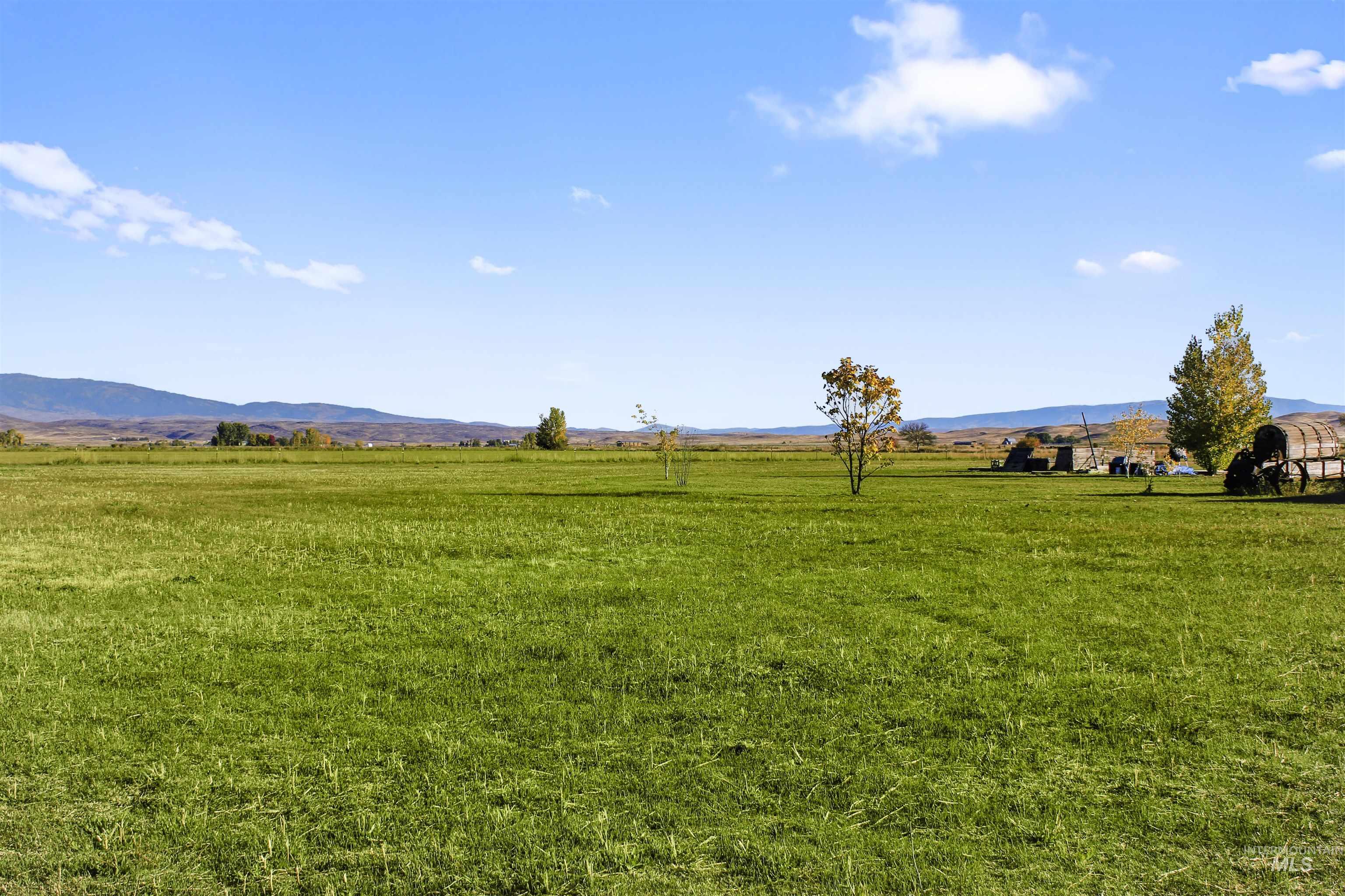 View of grassy yard with a view of rural / pastoral area and a mountain view