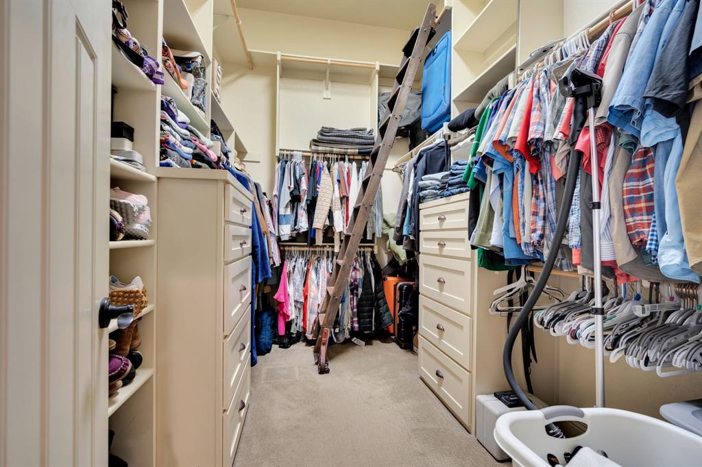 409 George Hopper Road Midlothian, TX 76065 - Photo 12 of 26 a view of walk in closet with clothes and shoes