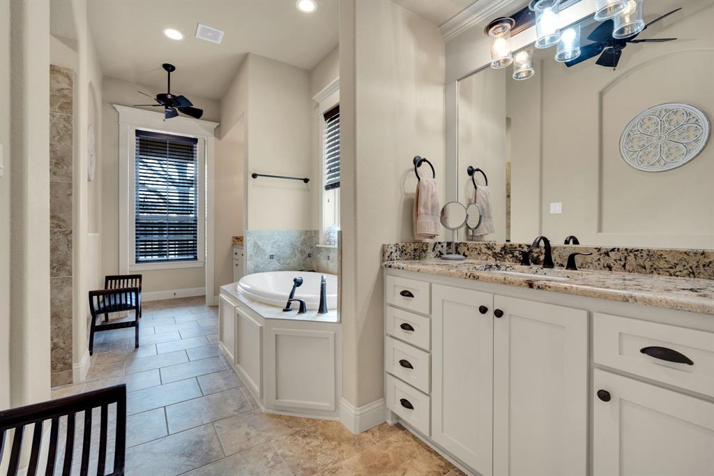 409 George Hopper Road Midlothian, TX 76065 - Photo 13 of 26 a spacious bathroom with a granite countertop sink mirror and bathtub