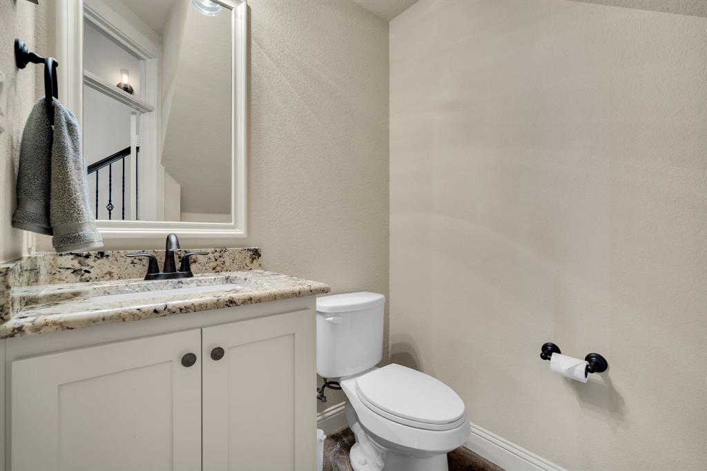 409 George Hopper Road Midlothian, TX 76065 - Photo 17 of 26 a bathroom with a granite countertop toilet sink and mirror