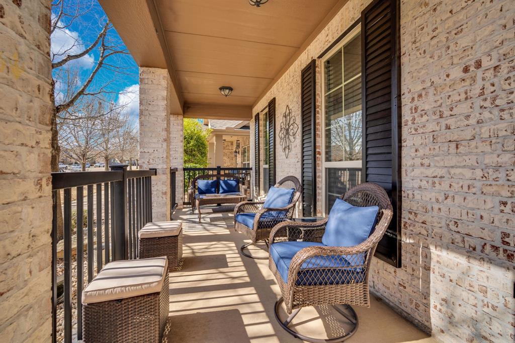 409 George Hopper Road Midlothian, TX 76065 - Photo 2 of 26 a balcony with chairs and a potted plant on a table