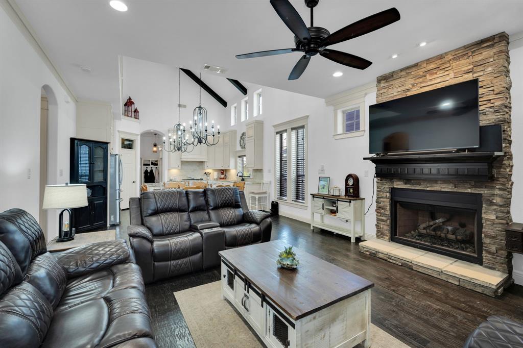 409 George Hopper Road Midlothian, TX 76065 - Photo 3 of 26 a living room with furniture a flat screen tv and a fireplace