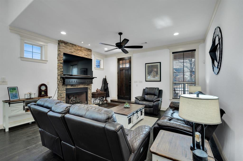 409 George Hopper Road Midlothian, TX 76065 - Photo 4 of 26 a living room with furniture a fireplace and a flat screen tv