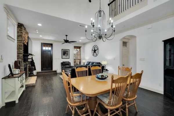 a view of a dining room with furniture wooden floor and chandelier