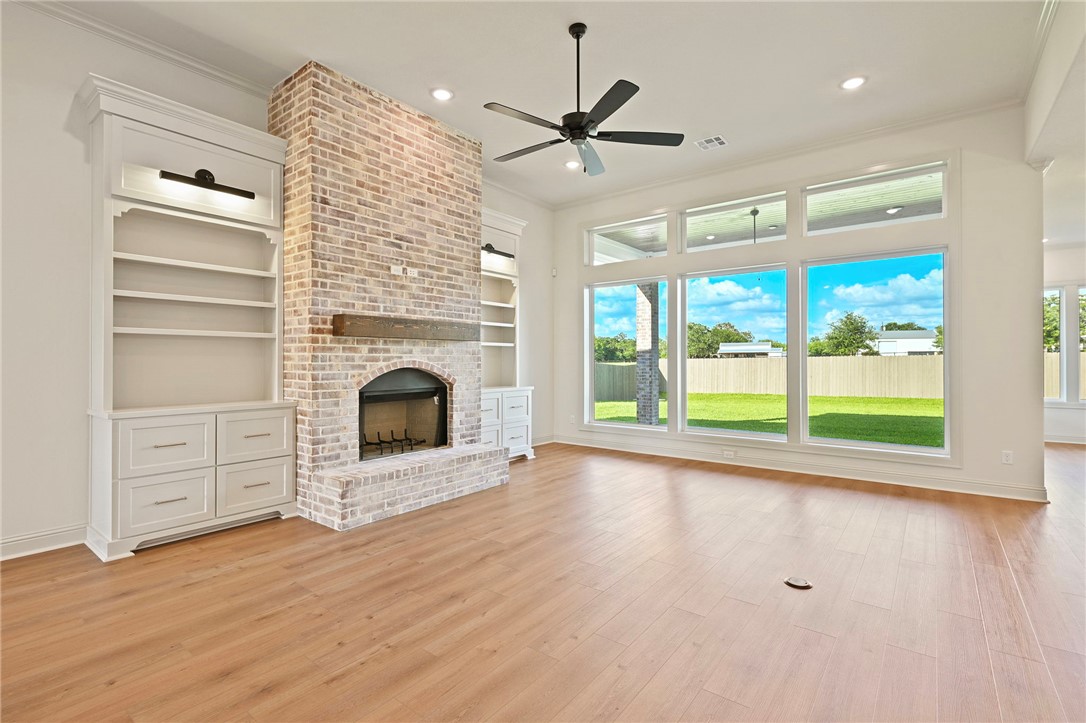 7052 Skipping Rock Path Bryan, TX 77808 - Photo 3 of 23 a view of an empty room with a fireplace and a window