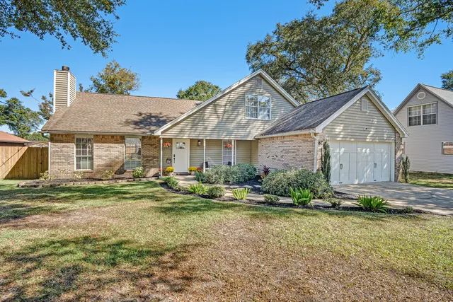 a front view of a house with a yard outdoor seating and garage
