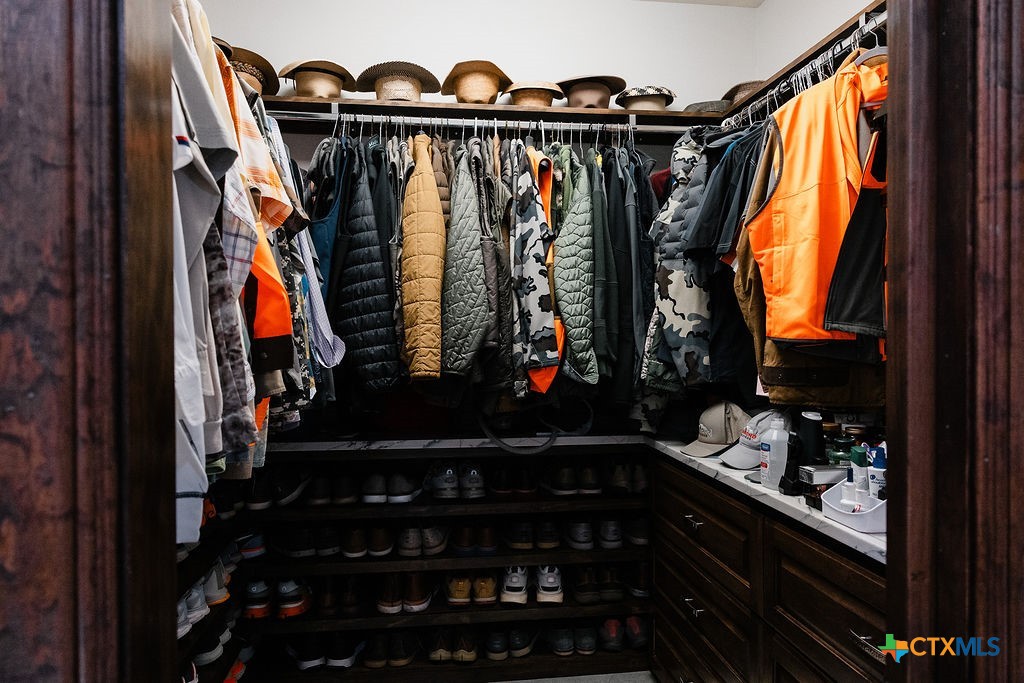 436 Jentry Road Inez, TX 77968 - Photo 11 of 42 a view of walk in closet with clothes and shoes