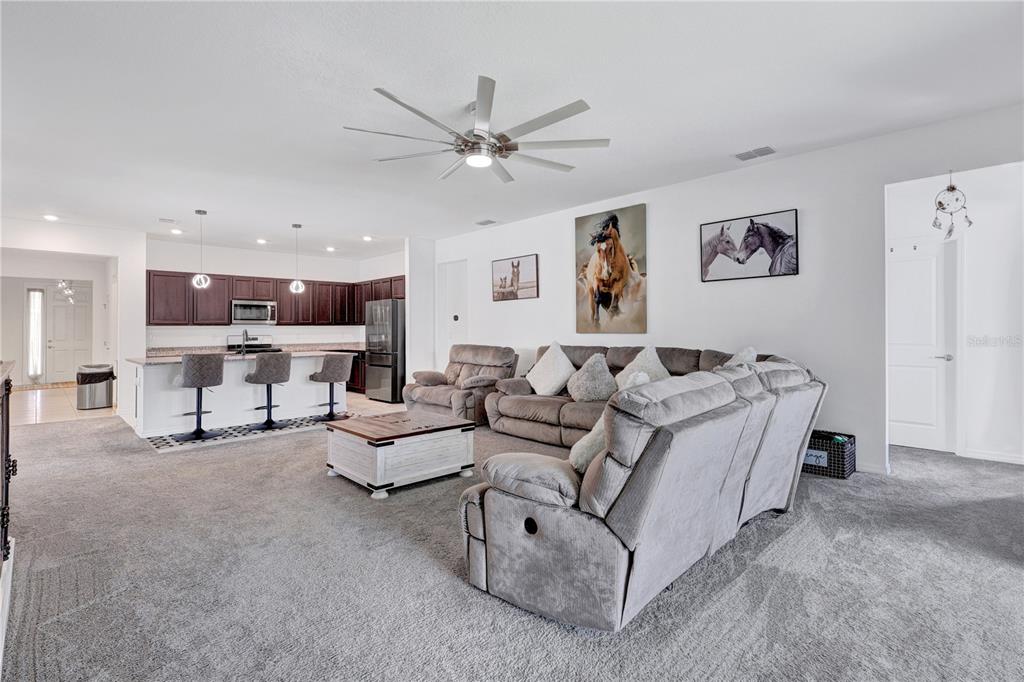 7185 Southwest 63rd Street Ocala, FL 34474 - Photo 10 of 31 a bed room with furniture and a ceiling fan