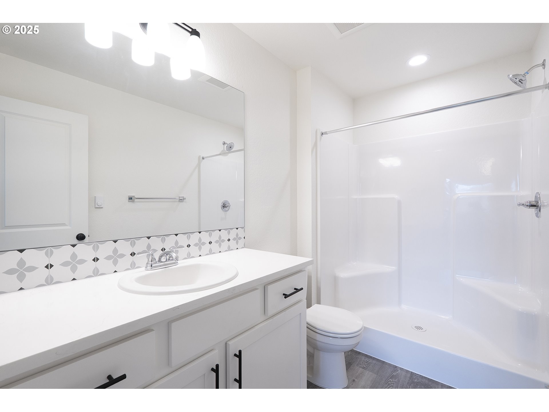 14718 Southeast Powell Boulevard Portland, OR 97236 - Photo 7 of 15 a bathroom with a sink a toilet and a large mirror