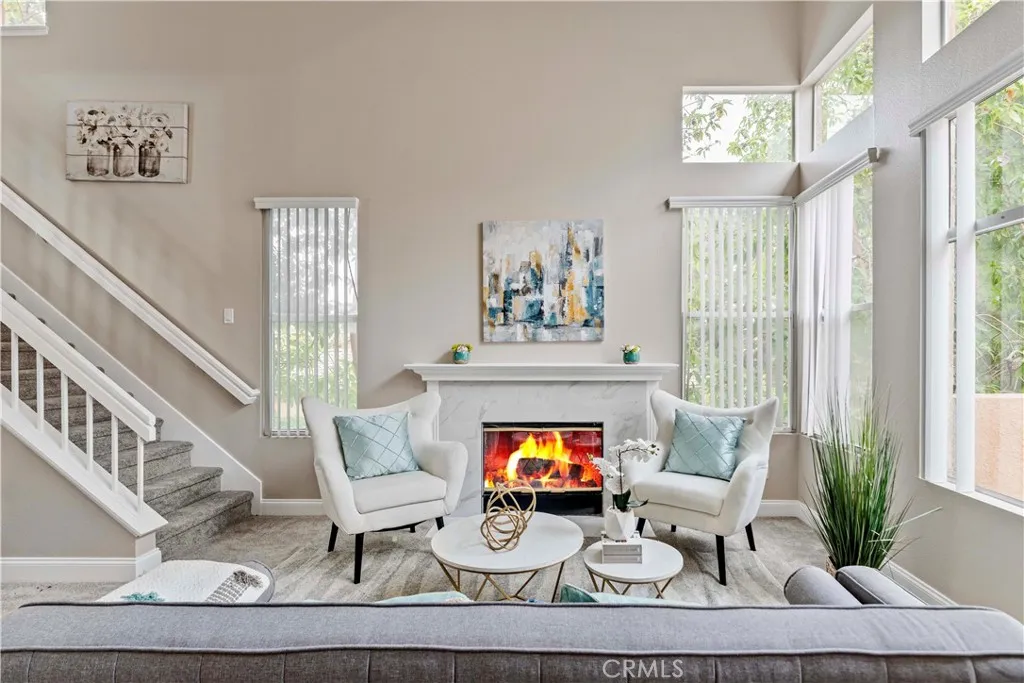 19431 Rue De Valore Lake Forest, CA 92610 - Photo 5 of 12 a living room with furniture a fireplace and a large window