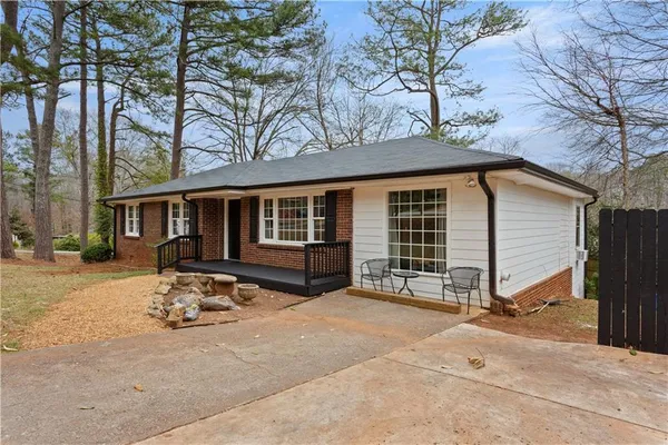 a view of a house with a patio and a yard