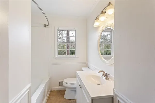 a bathroom with a sink toilet a mirror and tub