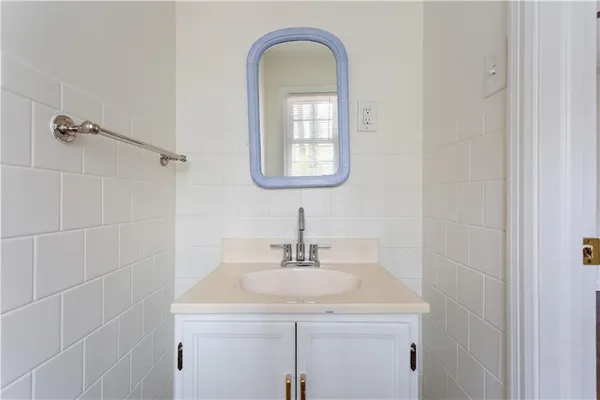 a bathroom with a toilet a sink a vanity and mirror