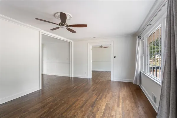 wooden floor in an empty room with a window