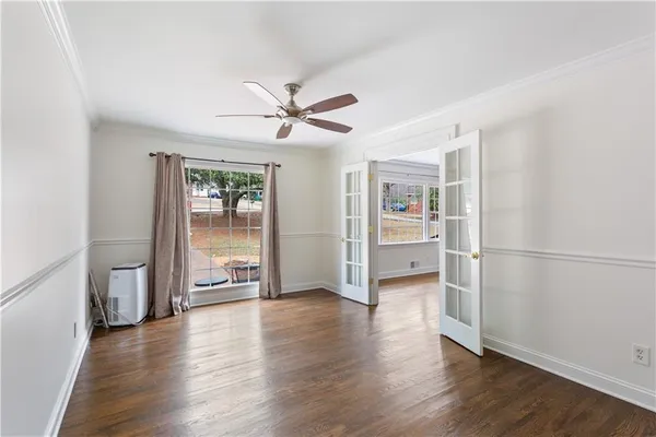 wooden floor in an empty room with a window