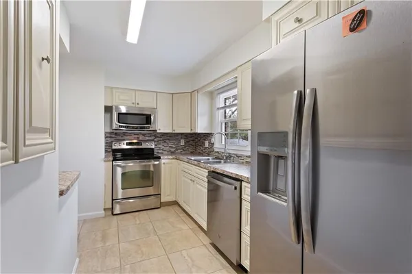 a kitchen with cabinets and stainless steel appliances