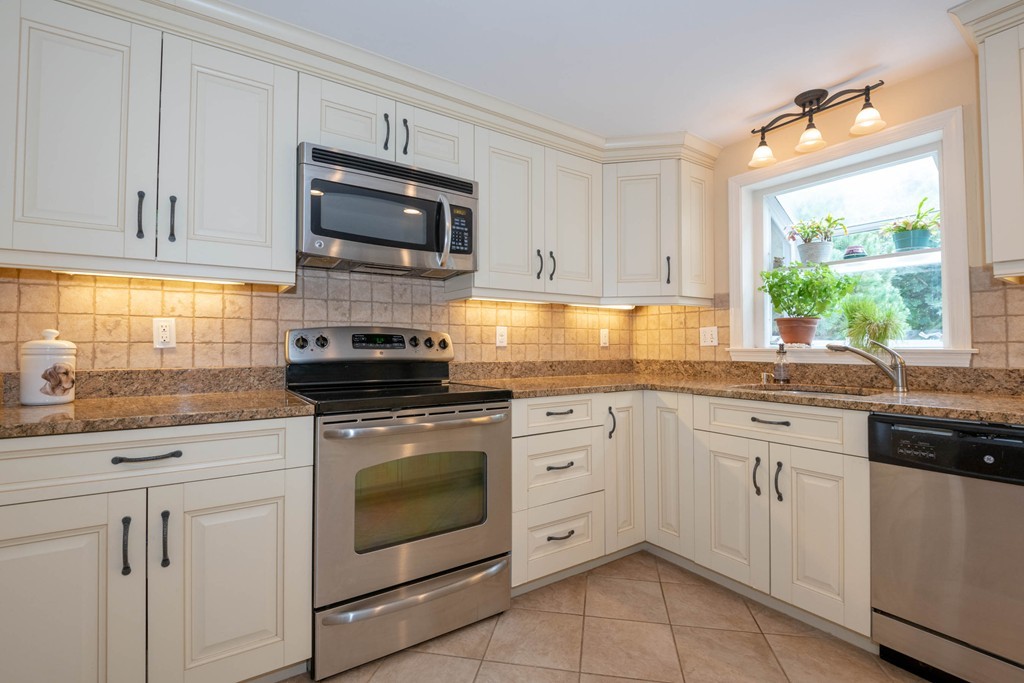 24 Hawthorn Road Marblehead, MA 01945 - Photo 14 of 30 a kitchen with granite countertop white cabinets appliances a sink and a window