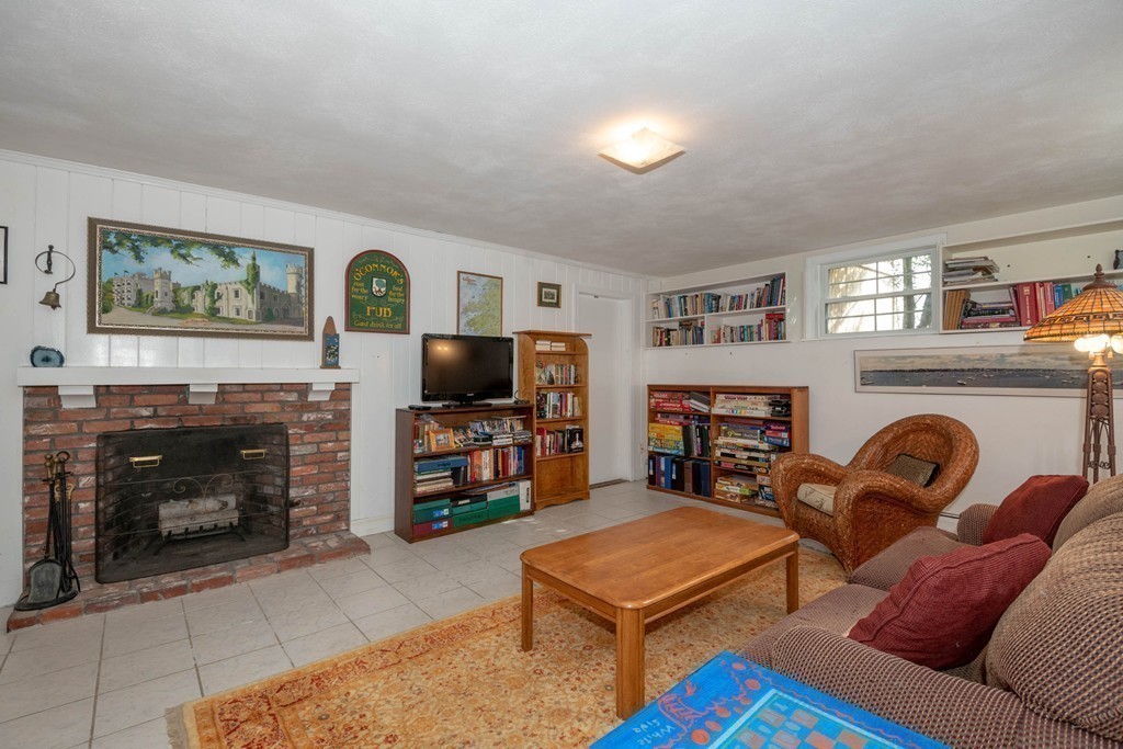 24 Hawthorn Road Marblehead, MA 01945 - Photo 27 of 30 a living room with furniture a flat screen tv and a fireplace