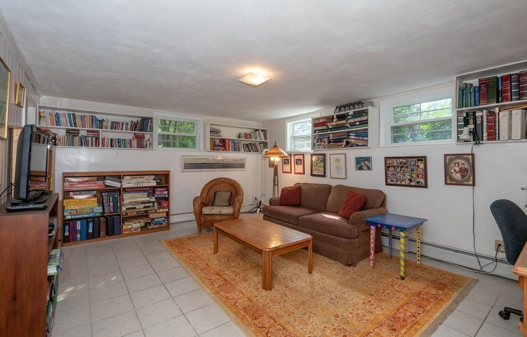 24 Hawthorn Road Marblehead, MA 01945 - Photo 28 of 30 a living room with furniture a flat screen tv and a fireplace