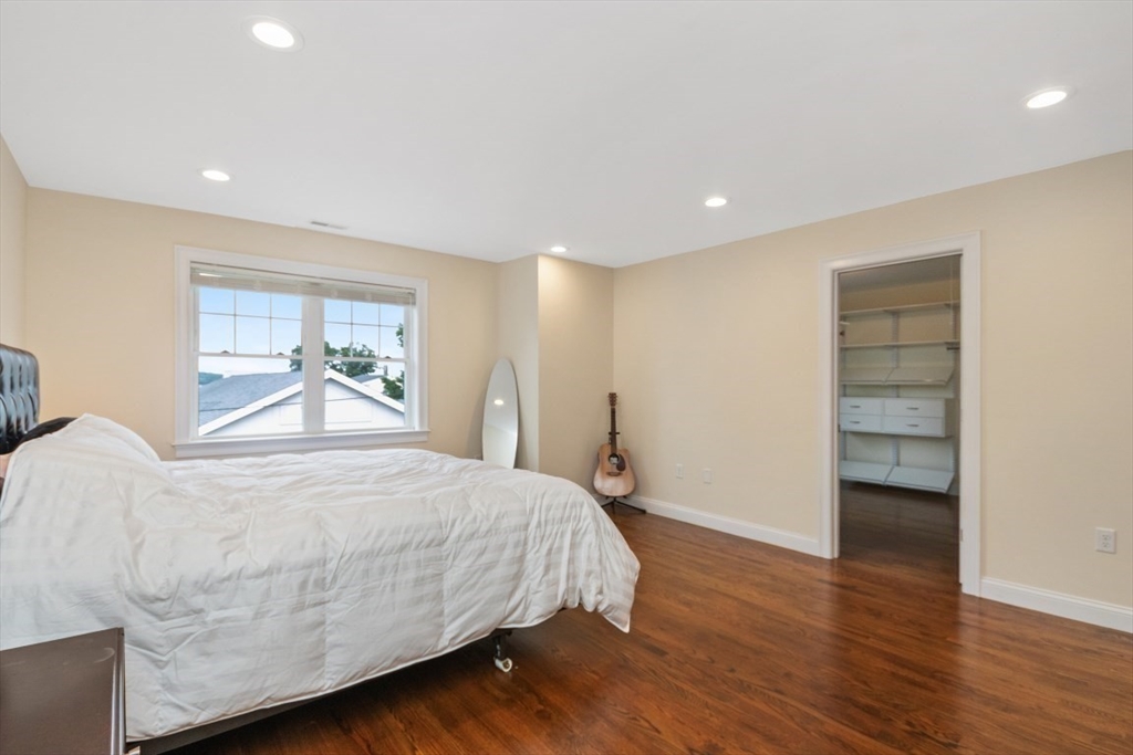 141 Ash Street, Unit 1 Waltham, MA 02453 - Photo 13 of 31 a bedroom with a bed and a cabinets