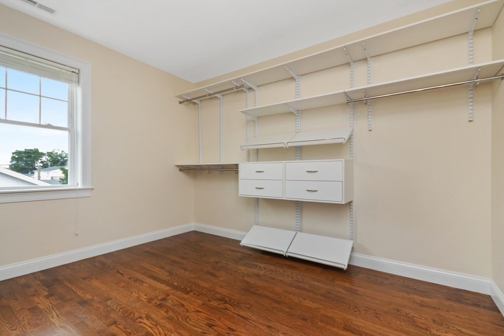 141 Ash Street, Unit 1 Waltham, MA 02453 - Photo 15 of 31 a view of an empty room with a window and wooden floor