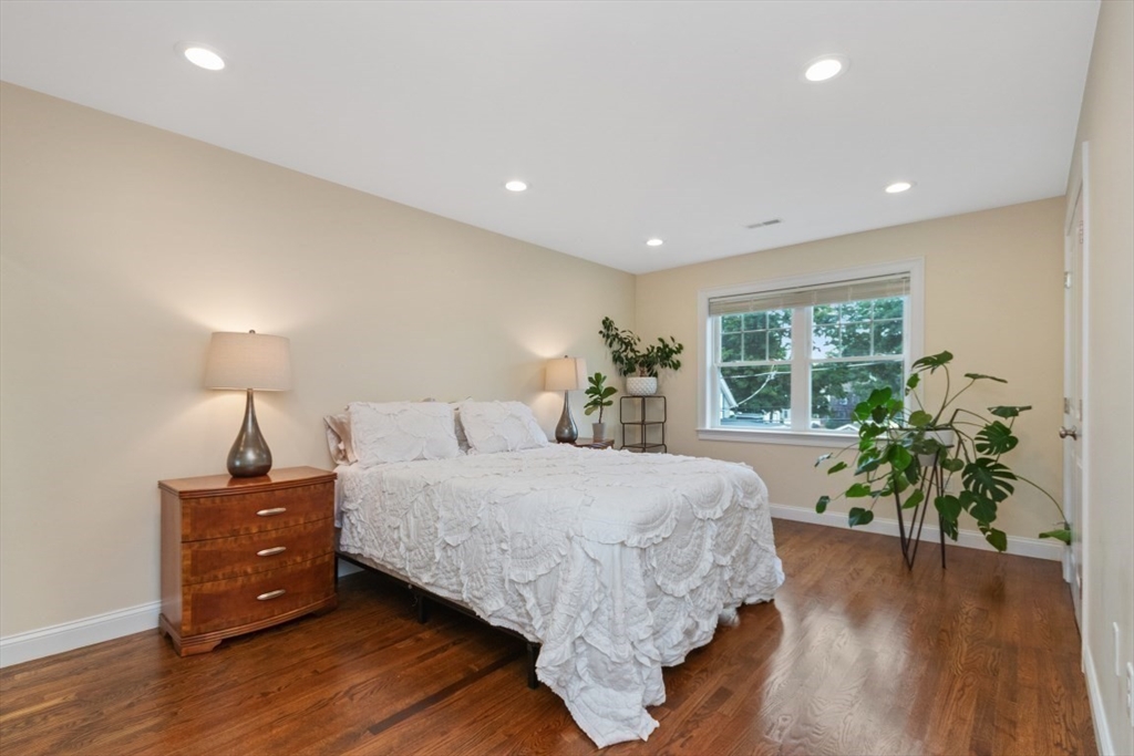 141 Ash Street, Unit 1 Waltham, MA 02453 - Photo 19 of 31 a bed room with a bed and a potted plant