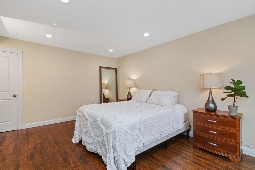 141 Ash Street, Unit 1 Waltham, MA 02453 - Photo 20 of 31 a bedroom with a bed and a dresser
