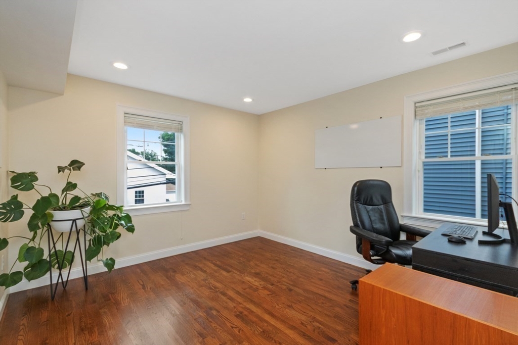 141 Ash Street, Unit 1 Waltham, MA 02453 - Photo 21 of 31 a workspace with furniture and a potted plant