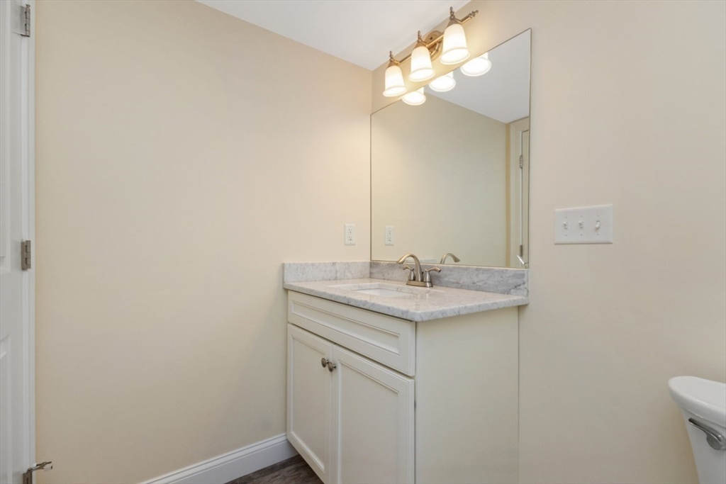 141 Ash Street, Unit 1 Waltham, MA 02453 - Photo 29 of 31 a bathroom with a sink and a mirror