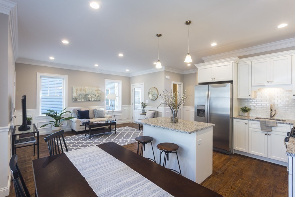 141 Ash Street, Unit 1 Waltham, MA 02453 - Photo 3 of 31 a large kitchen with kitchen island a large window