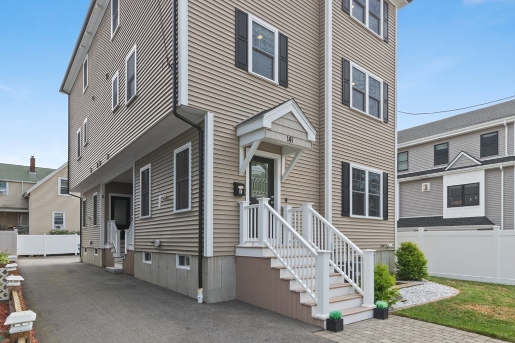 141 Ash Street, Unit 1 Waltham, MA 02453 - Photo 31 of 31 a front view of a house with a yard