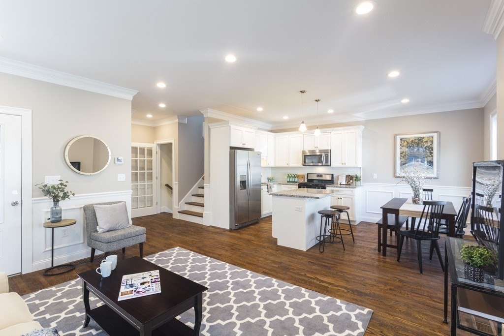 141 Ash Street, Unit 1 Waltham, MA 02453 - Photo 5 of 31 a living room with lots of furniture and kitchen view