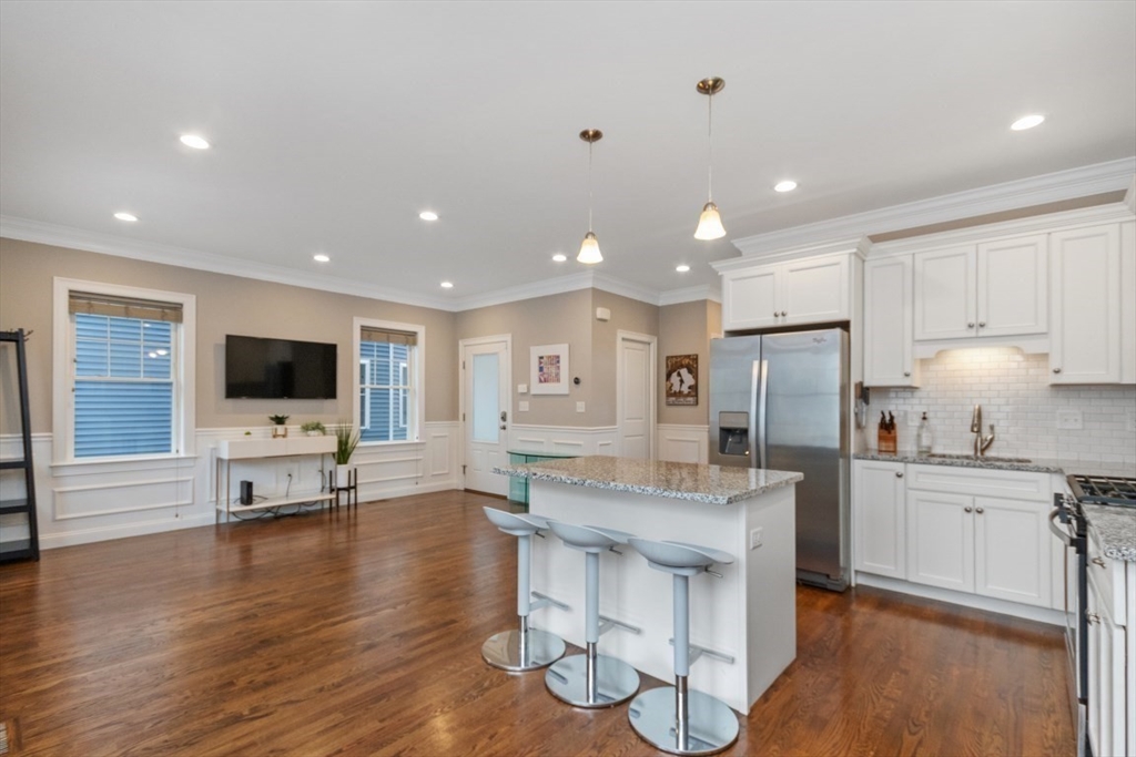 141 Ash Street, Unit 1 Waltham, MA 02453 - Photo 7 of 31 a living room with stainless steel appliances furniture and a flat screen tv