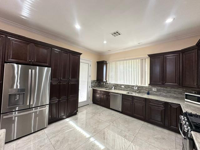 6830 North 14th Street Phoenix, AZ 85014 - Photo 6 of 28 a kitchen with stainless steel appliances granite countertop a refrigerator a stove a sink and a microwave
