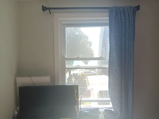 a bedroom with a bed and a chandelier fan