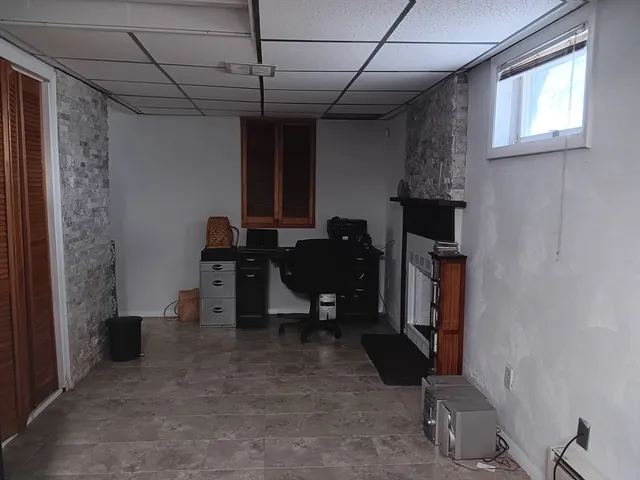 a bathroom with a granite countertop toilet and a shower
