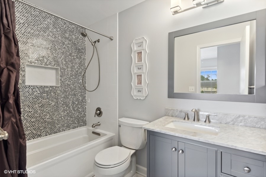 1052 Kufrin Way Lombard, IL 60148 - Photo 9 of 16 a bathroom with a granite countertop sink a toilet and shower